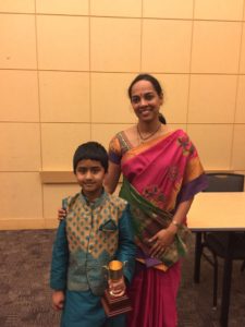 Avinesh with his first prize trophy along with one of the judges
